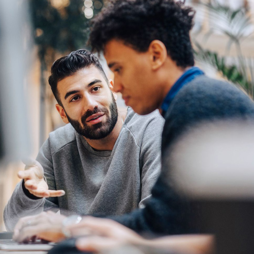 man explaining something to the person next to him