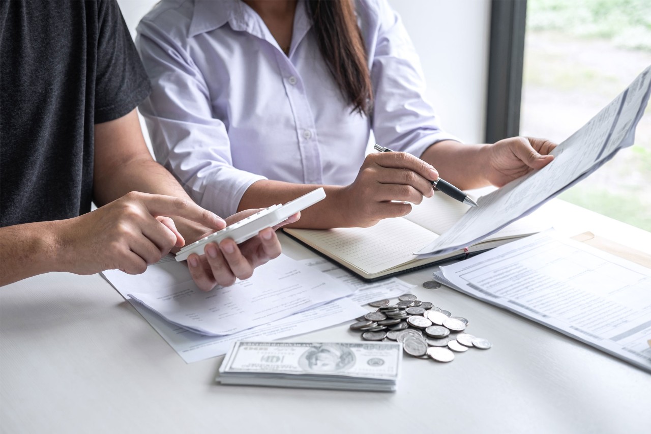 Two people calculating costs