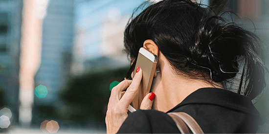Woman with red nail polish on the phone