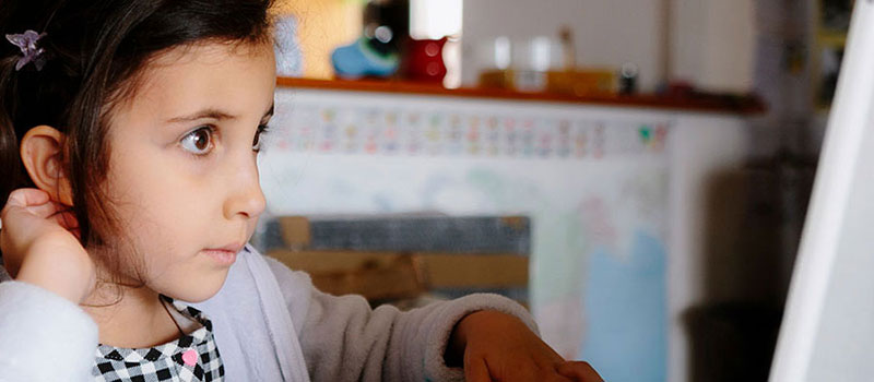 Kid Using A Laptop At Home