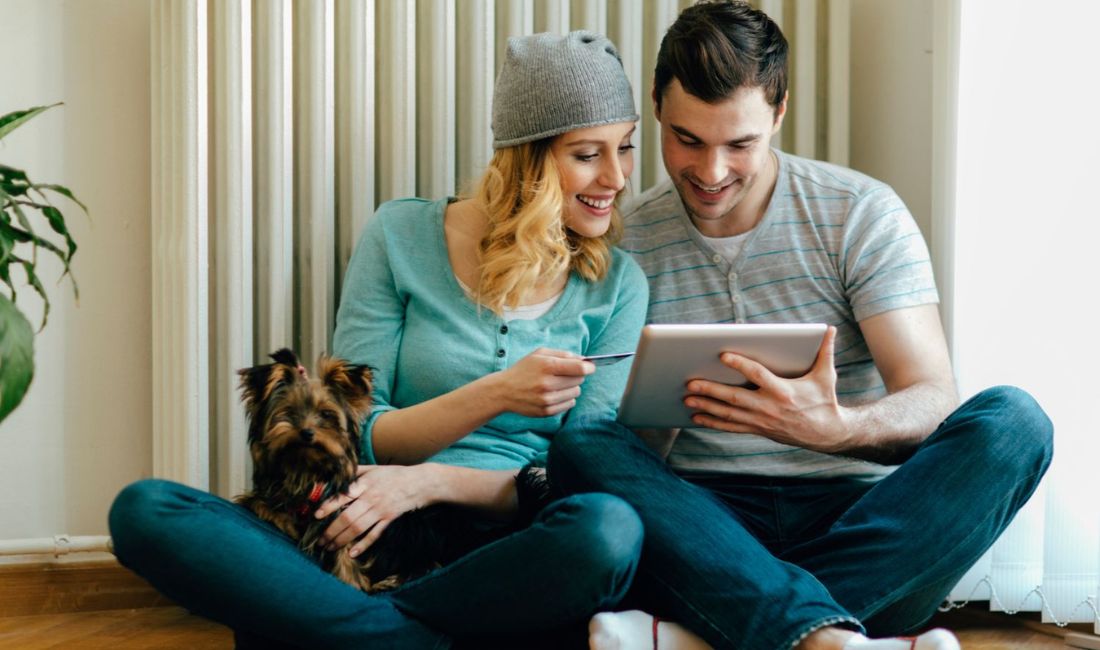 man woman dog with tablet
