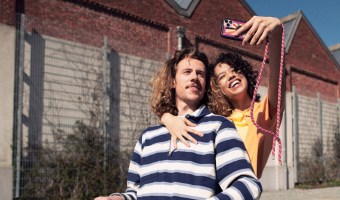 Boy and girl in the sun taking a selfie