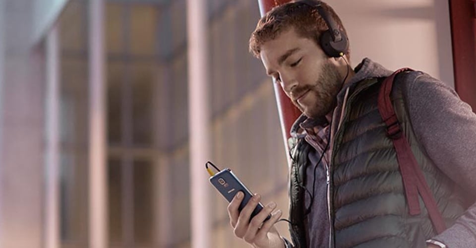 4G man headphones looking at phone